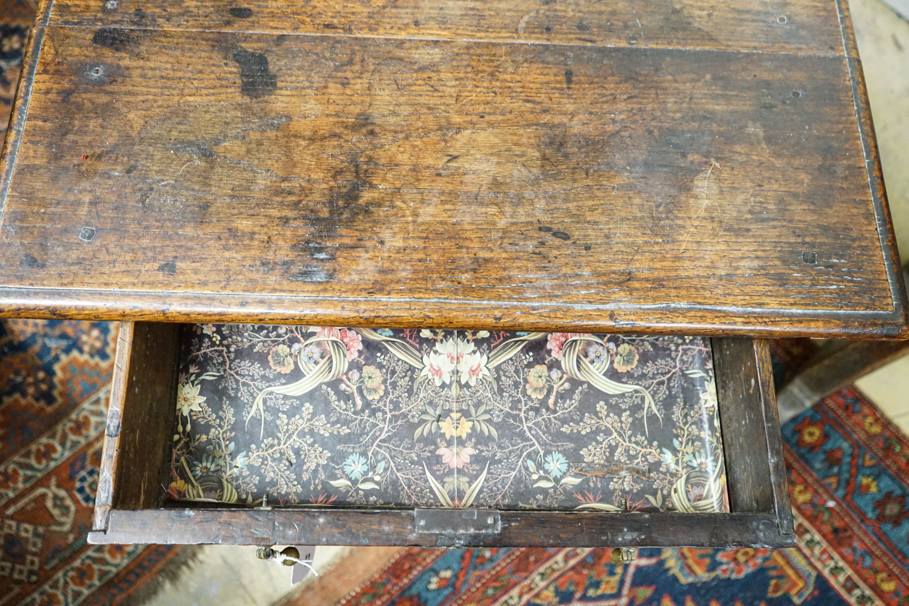 An early 18th century oak lowboy, with single drawer and saltire stretcher, width 67cm, depth 46cm, height 64cm